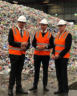 Tomra Cleanaway CEO James Dorney, Environment Minister Matt Kean and EPA’s Acting Chair Mark Gifford in front of piles of returned containers